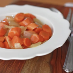 glazed carrots and onions in a white bowl