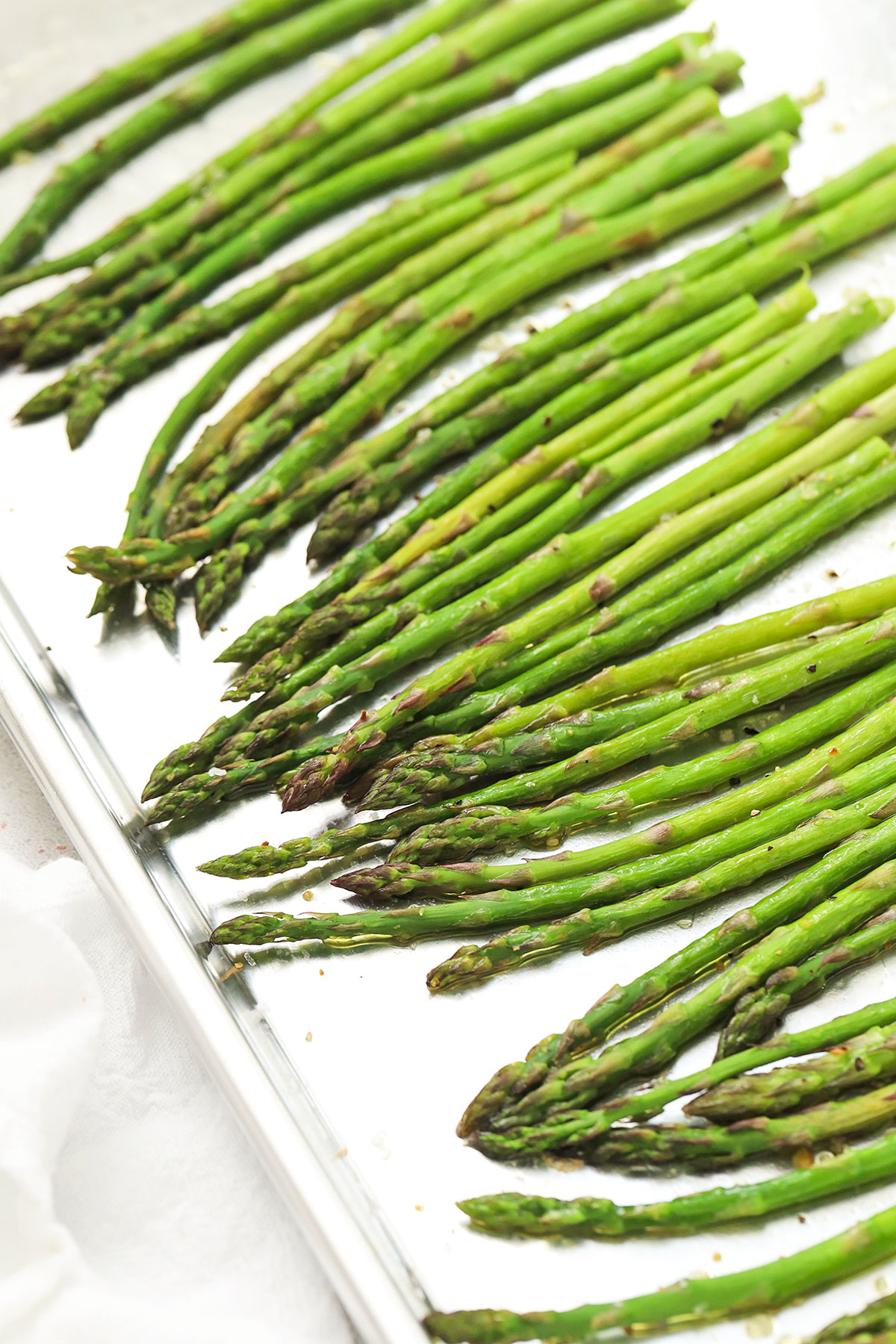 bright green roasted asparagus on a baking sheet