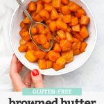 Setting down a bowl of Browned Butter Butternut Squash on a white background with text overlay that reads "gluten-free Browned Butter Butternut Squash"