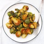 Overhead view of a plate of maple dijon roasted Brussels sprouts.