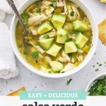 Salsa Verde Chicken Chili topped with diced avocado and minced cilantro with text overlay that reads "Easy + Delicious Salsa Verde Chicken Chili"