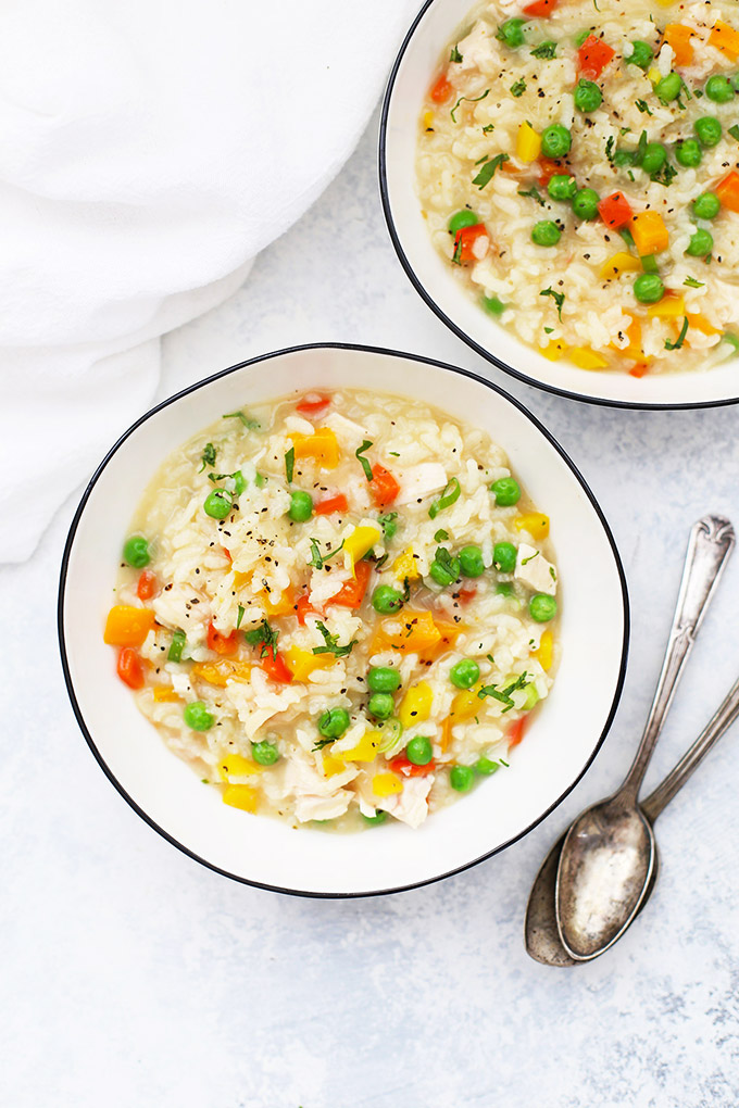 Two bowls of Chicken Vegetable Risotto with spoons.