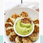 Paleo & Whole30 Chicken Zucchini Poppers on a plate with a bowl of avocado dip and text overlay that reads "paleo + whole30 + gluten-free chicken zucchini poppers"