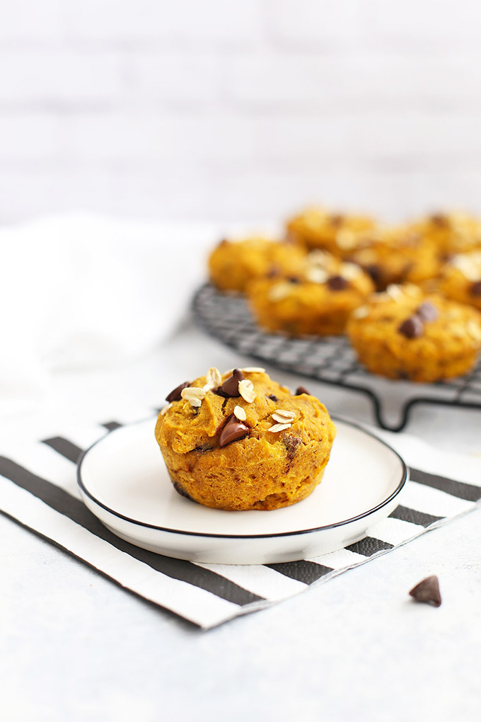 Gluten Free Pumpkin Chocolate Chip Muffin on a plate with a striped napkin. 