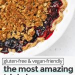 Close up view of a freshly baked triple berry crumble pie with bubble berry filling and golden crumble topping with text overlay that reads "gluten-free & vegan-friendly: the most amazing triple berry crumble pie: simple + pretty + delicious"