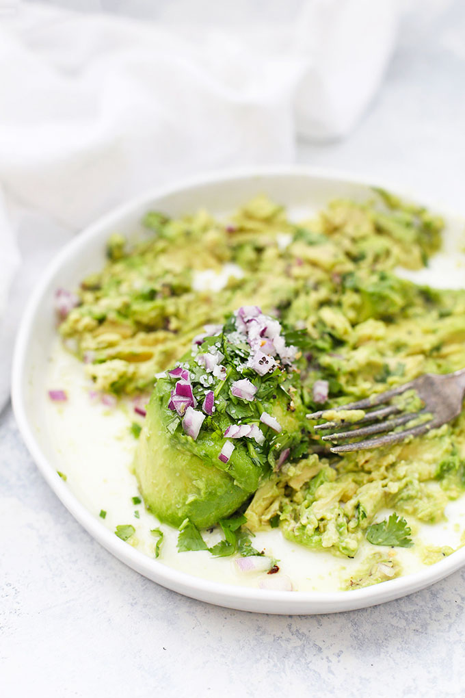 Mashing together ingredients for Classic Guacamole from One Lovely Life