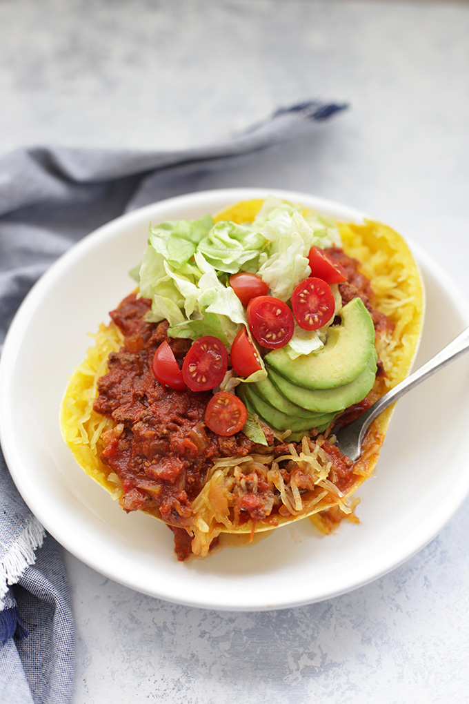 Chili Stuffed Spaghetti Squash - These stuffed spaghetti squash boats are loaded with goodies. Add your favorite taco toppings for a delicious, low-carb dinner!