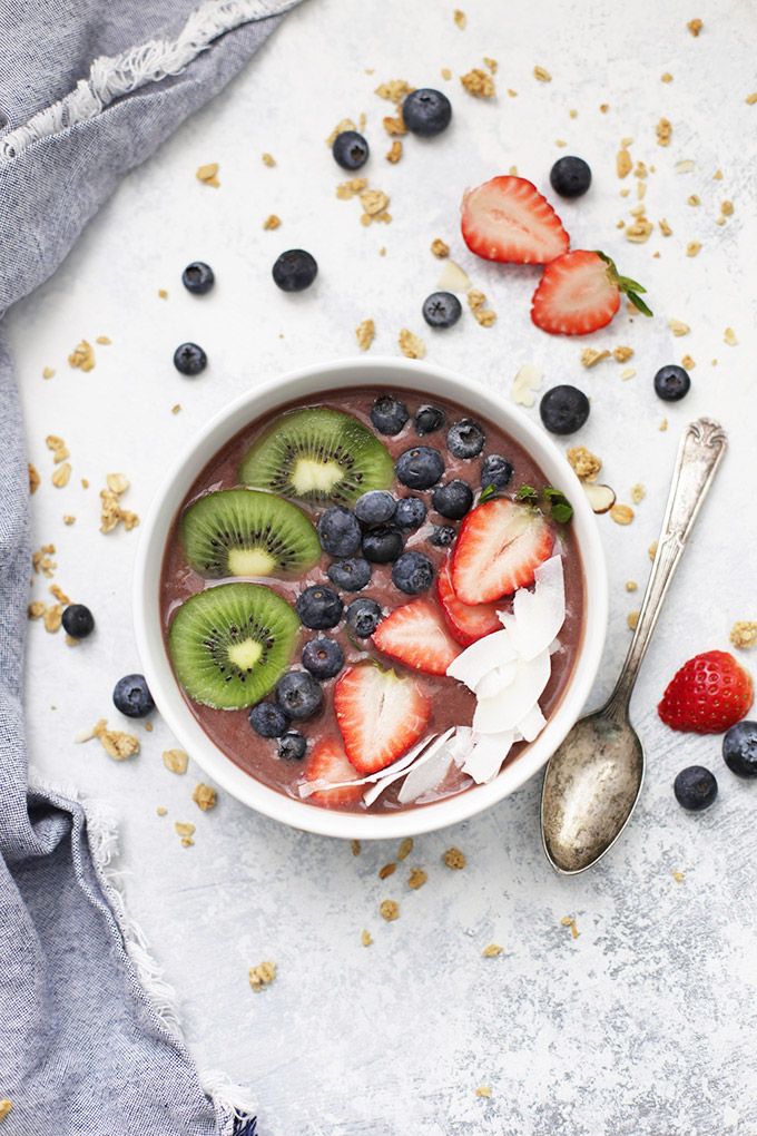 Fresh Acai Bowl topped with kiwi, blueberries, strawberries, and coconut from One Lovely Life