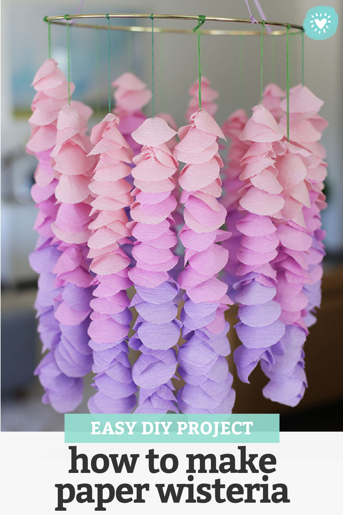 Crepe Paper Wisteria Hanging from a Gold Embroidery Hoop with text overlay that reads "Easy DIY Project - How to Make Paper Wisteria"