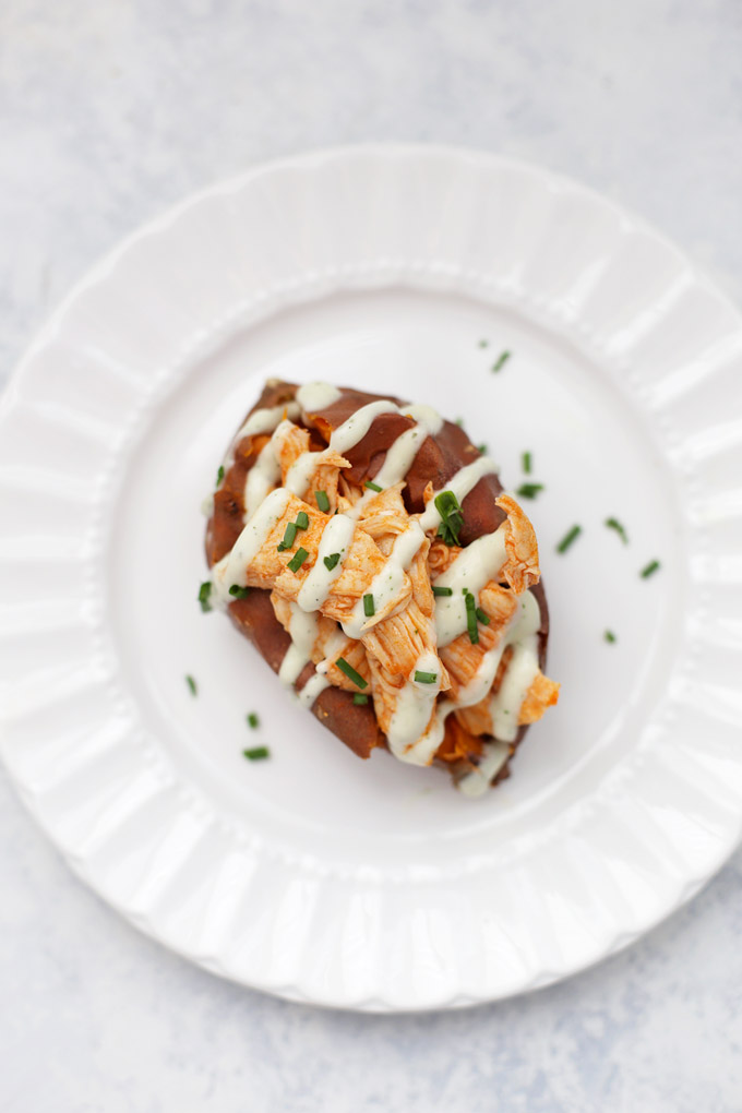 Buffalo Chicken Stuffed Sweet Potatoes - Spicy buffalo chicken drizzled with ranch and fresh chives. 5 other AMAZING ideas for baked potatoes in the same post!