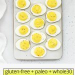 Overhead view of classic deviled eggs on a white egg platter with text overlay that reads "gluten-free + paleo + whole30 Classic Deviled Eggs"