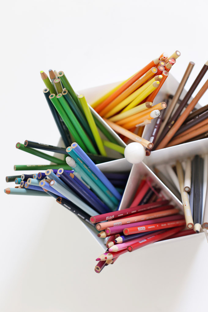 Overhead view of colored pencils in a lazy susan organized by color