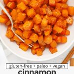 Overhead view of cinnamon roasted butternut squash in a white bowl with text overlay that reads "gluten-free + paleo + vegan cinnamon roasted butternut squash: easy + healthy + so delicious"