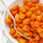 Front view of cinnamon roasted butternut squash in a white bowl