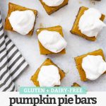 Overhead view of squares of gluten-free pumpkin pie bars with ginger cookie crust on a white background with text overlay that reads "Gluten + Dairy-Free Pumpkin Pie Bars with Ginger Cookie Crust"