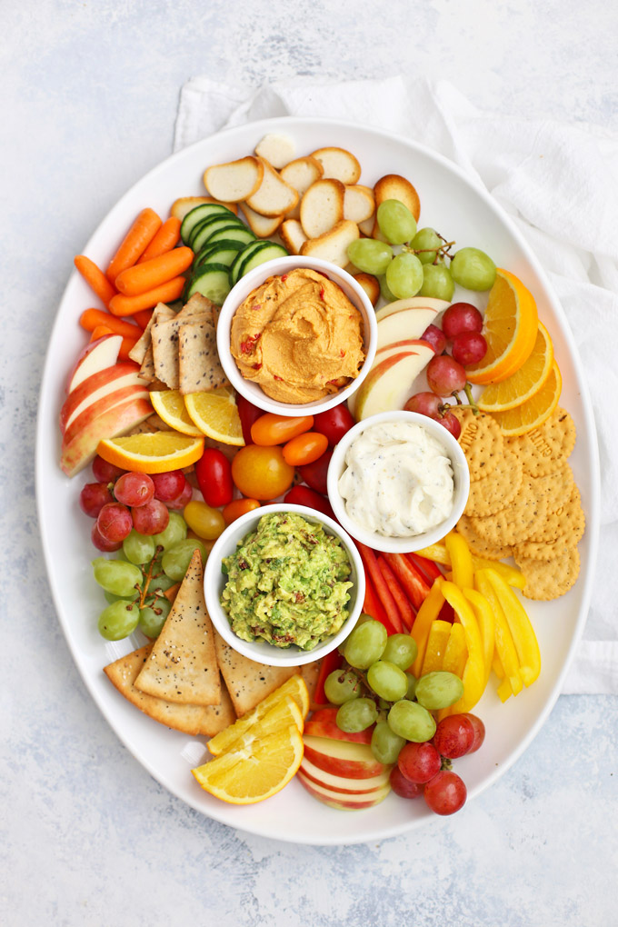 How to Make a Healthy Snack Board - An awesome hostess trick! (Plus, an amazing sun dried tomato avocado dip with gluten free flatbread crackers!) 