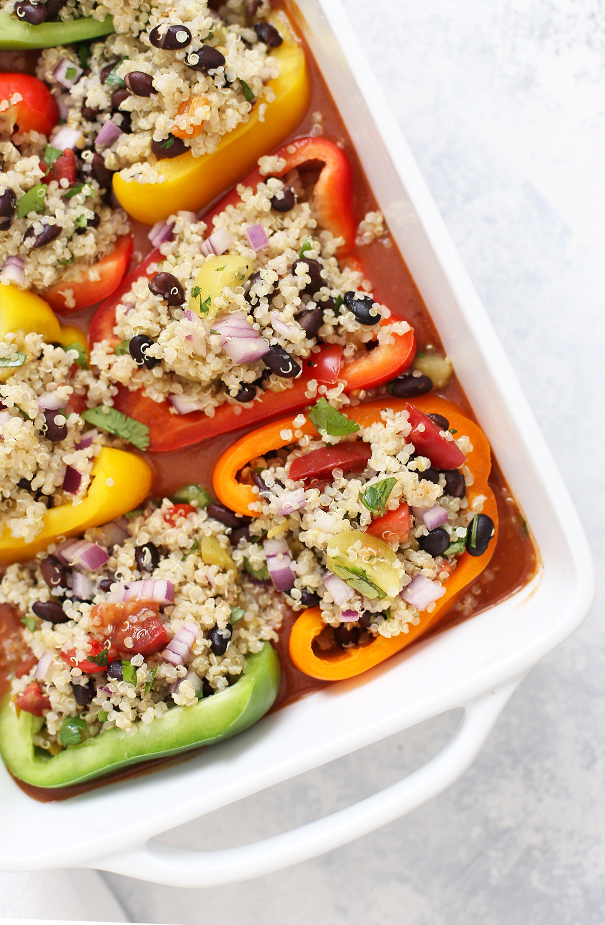 Overhead view of colorful stuffed peppers with Tex-Mex Quinoa Filling.