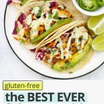 Overhead view of fish tacos with text overlay that reads "(gluten-free) The BEST EVER Fish Tacos with Honey Lime Slaw: So many great reviews."