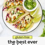 Overhead view of fish tacos with text overlay that reads "(gluten-free) The BEST EVER Fish Tacos with Honey Lime Slaw."