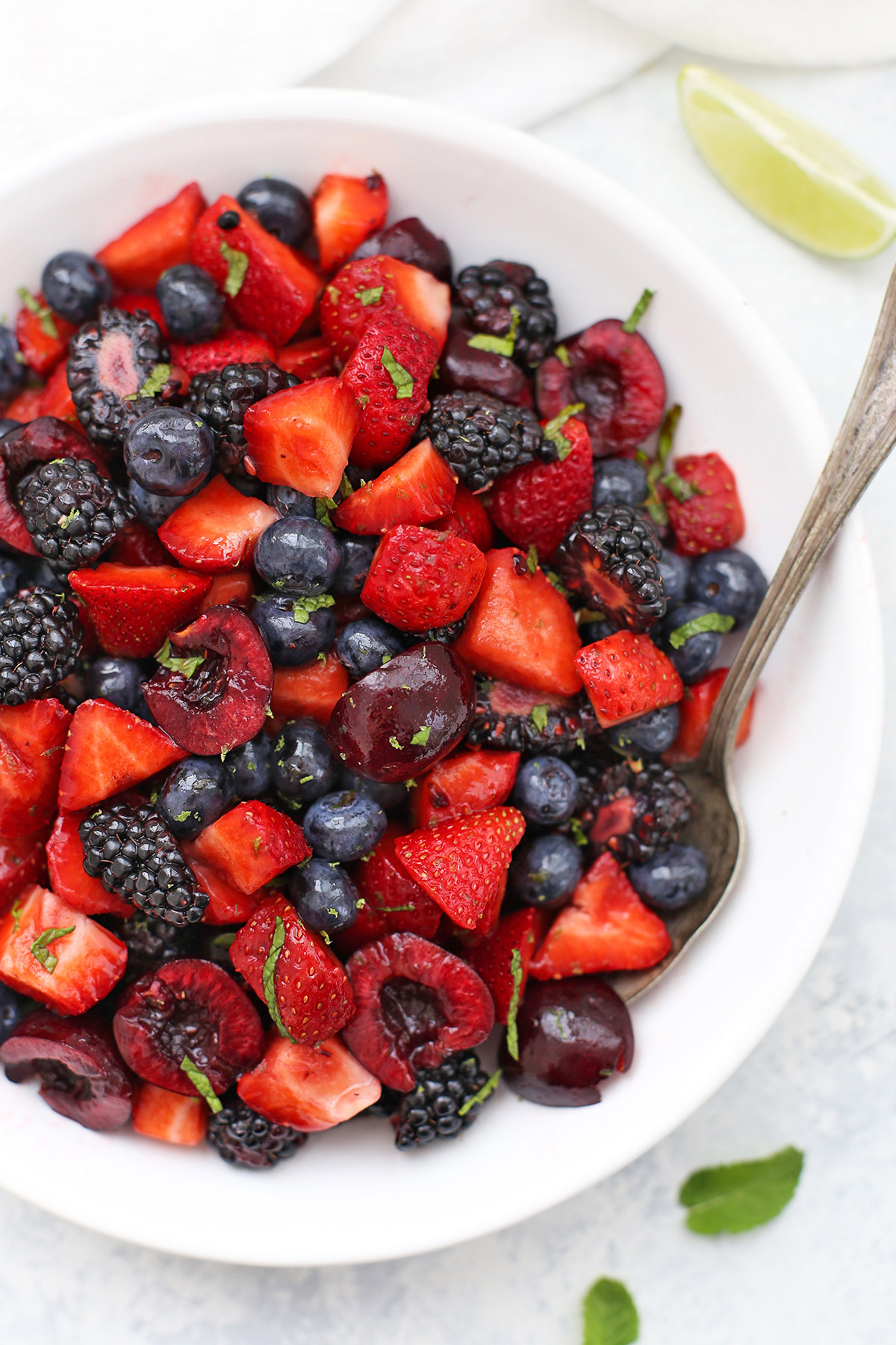 Cherry Berry Fruit Salad with Lime Mint Dressing - Strawberries, blackberries, blueberries, and cherries with lime mint dressing. 