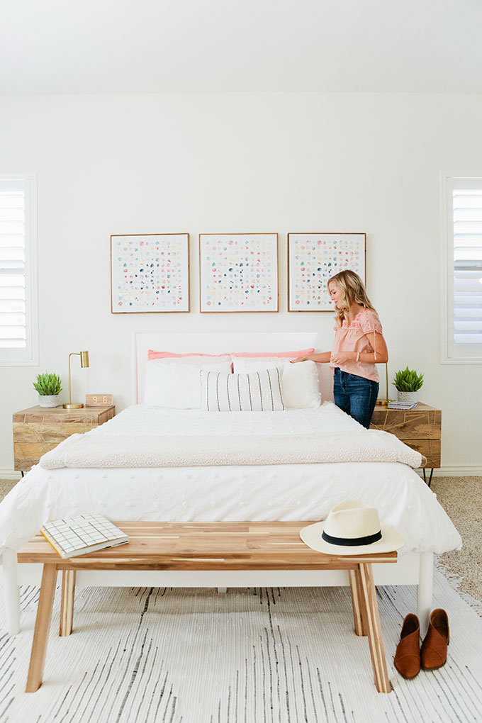 Emily of One Lovely Life styling pillows in her master bedroom, redesigned by Modsy. 