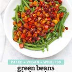 Top view of a plate of green beans with balsamic pepper relish on top with text overlay that reads "Paleo + Vegan + Whole30 Green Beans with Balsamic Pepper Relish"