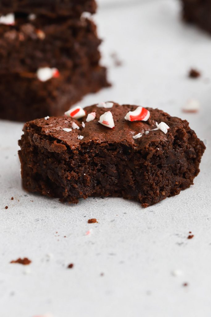 Front view of a gluten-free peppermint brownie with a bite taken out of it