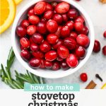 Close up view of Ingredients for Stovetop Christmas Potpourri - Cranberries, oranges, rosemary, cinnamon sticks, and whole cloves with text overlay that reads "How to Make Stovetop Christmas Potpourri +Free Printable Gift Tags"