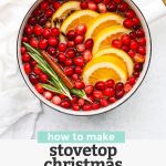 Overhead view of Christmas potpourri in a white saucepan with water. with text overlay that reads "How to Make Stovetop Christmas Potpourri +Free Printable Gift Tags"