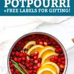 Christmas potpourri in a white saucepan with water with text that reads "How to Make Christmas Potpourri + Free Labels for Gifting!"