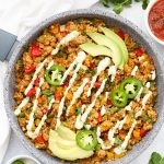 Taco Cauliflower Rice Skillet topped with sliced avocado & jalapeño, and drizzled with cilantro lime ranch dressing from One Lovely Life