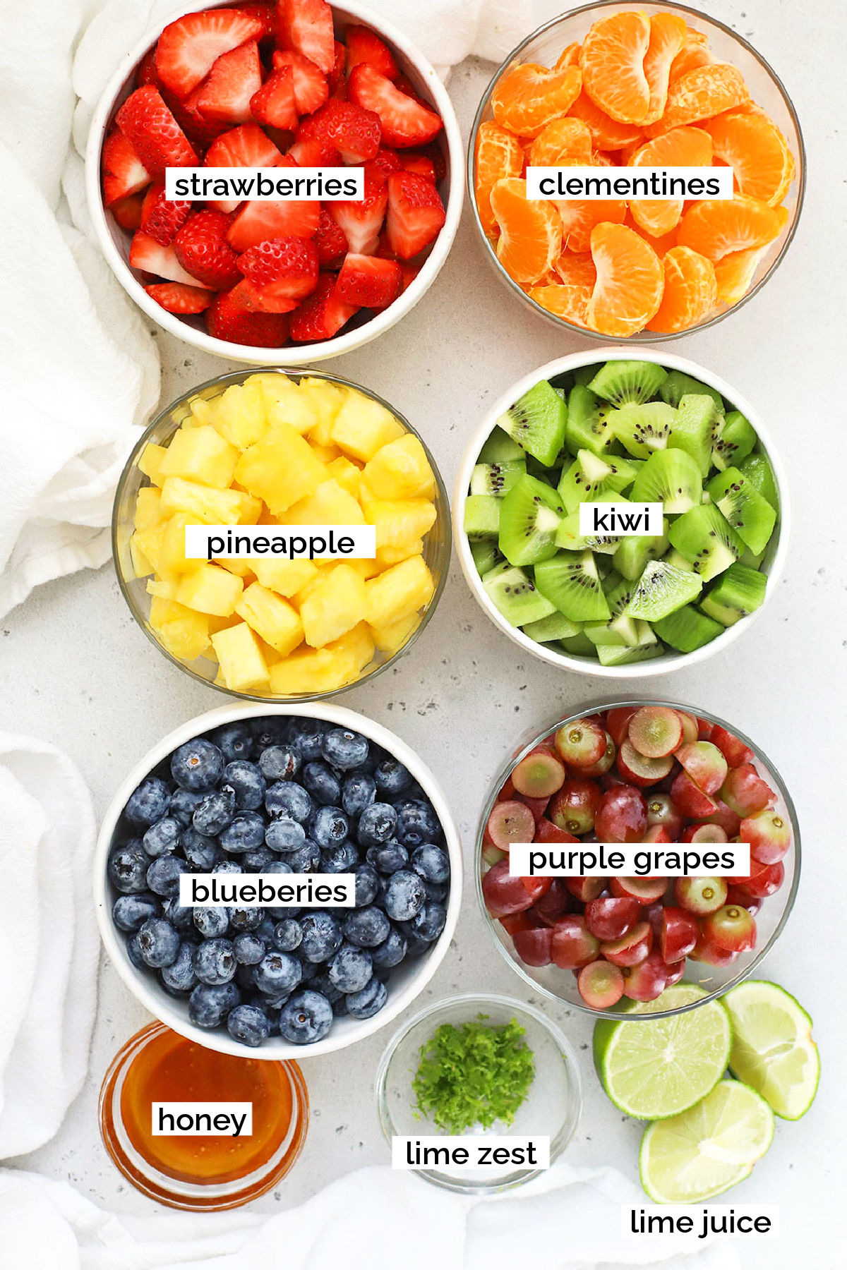ingredients for rainbow fruit salad in small bowls