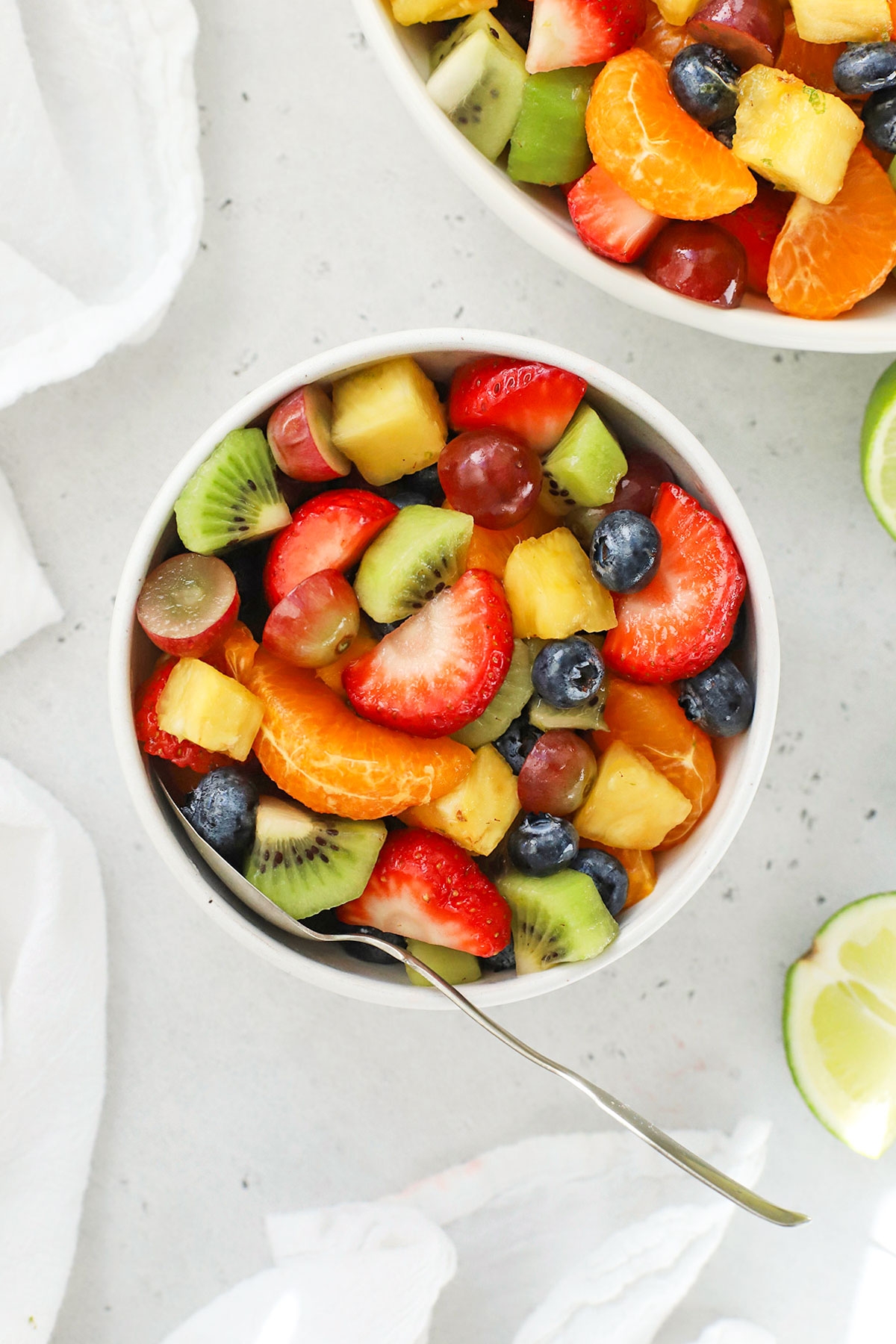 A small white bowl of colorful fruit salad