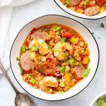 Two bowls of paleo jambalaya made with cauliflower rice from One Lovely Life.