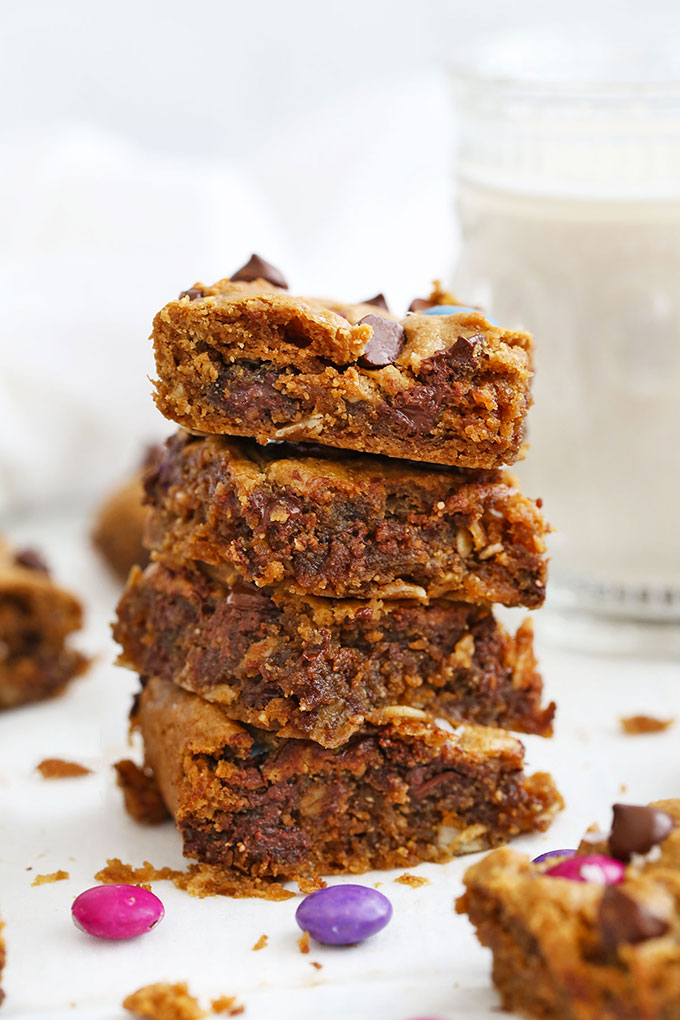Stack of Flourless Monster Cookies Bars with gooey centers.