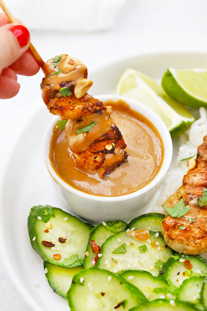 Grilled Chicken Satay dipped in creamy peanut sauce from One Lovely Life