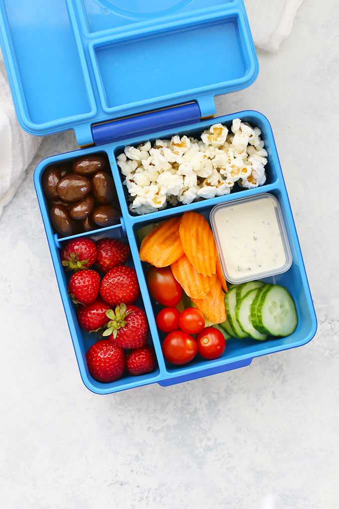 Gluten Free Dairy Free School Lunch with Dairy Free Ranch, Fresh Veggies, Popcorn, Strawberries, and Chocolate Covered Almonds