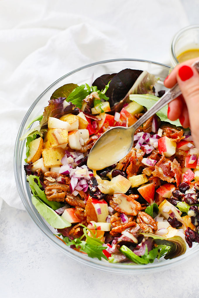 Drizzling Honey Mustard Dressing over Fall Chopped Salad from One Lovely Life