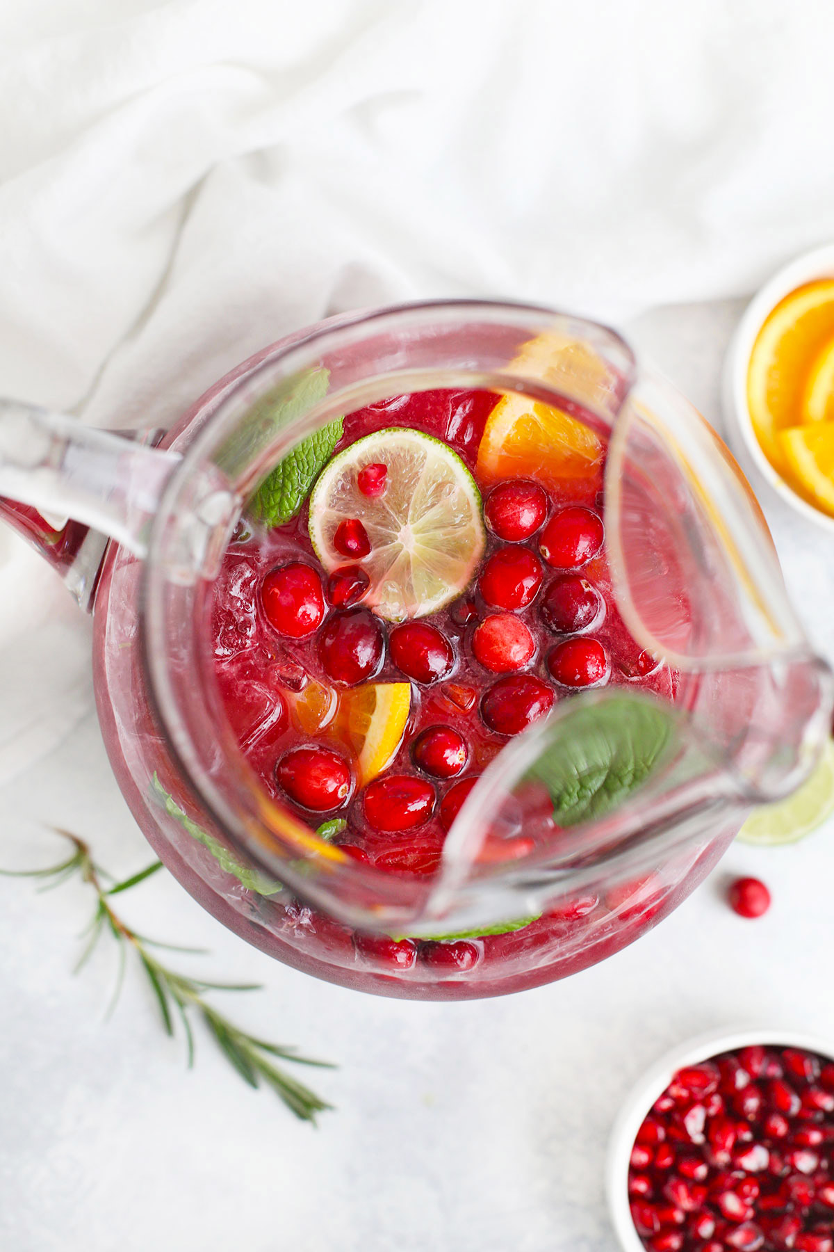 Overhead view of a pitcher of Sparkling Citrus Pomegranate Mocktail