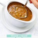 A ladle dipping into a white gravy boat full of mushroom gravy with text overlay that reads "Vegan + Paleo Simple Mushroom Gravy. Hearty + Savory + Delicious!"