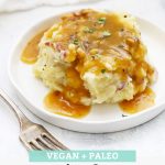 Scoop of Instant Pot Mashed Potatoes smothered in simple mushroom gravy with text overlay that reads "Vegan + Paleo Simple Mushroom Gravy. Hearty + Savory + Delicious!"