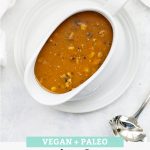 Overhead view of a white gravy boat full of paleo and vegan mushroom gravy from One Lovely Life with text overlay that reads "Vegan + Paleo Simple Mushroom Gravy. Hearty + Savory + Delicious!"