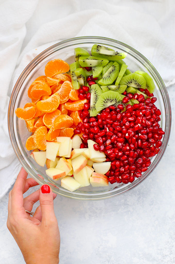 Apples, Oranges, Kiwi, and Pomegranate for Winter Fruit Salad with Citrus Dressing from One Lovely Life