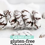 Front view of gluten-free chocolate crinkle cookies in a line with text overlay that reads "the best ever gluten-free chocolate crinkle cookies. Dairy-free + so chocolatey!"