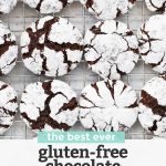 Overhead view of Gluten Free Chocolate Crinkle Cookies on a cooling rack with text overlay that reads "the best ever gluten-free chocolate crinkle cookies. Dairy-free + so chocolatey!"