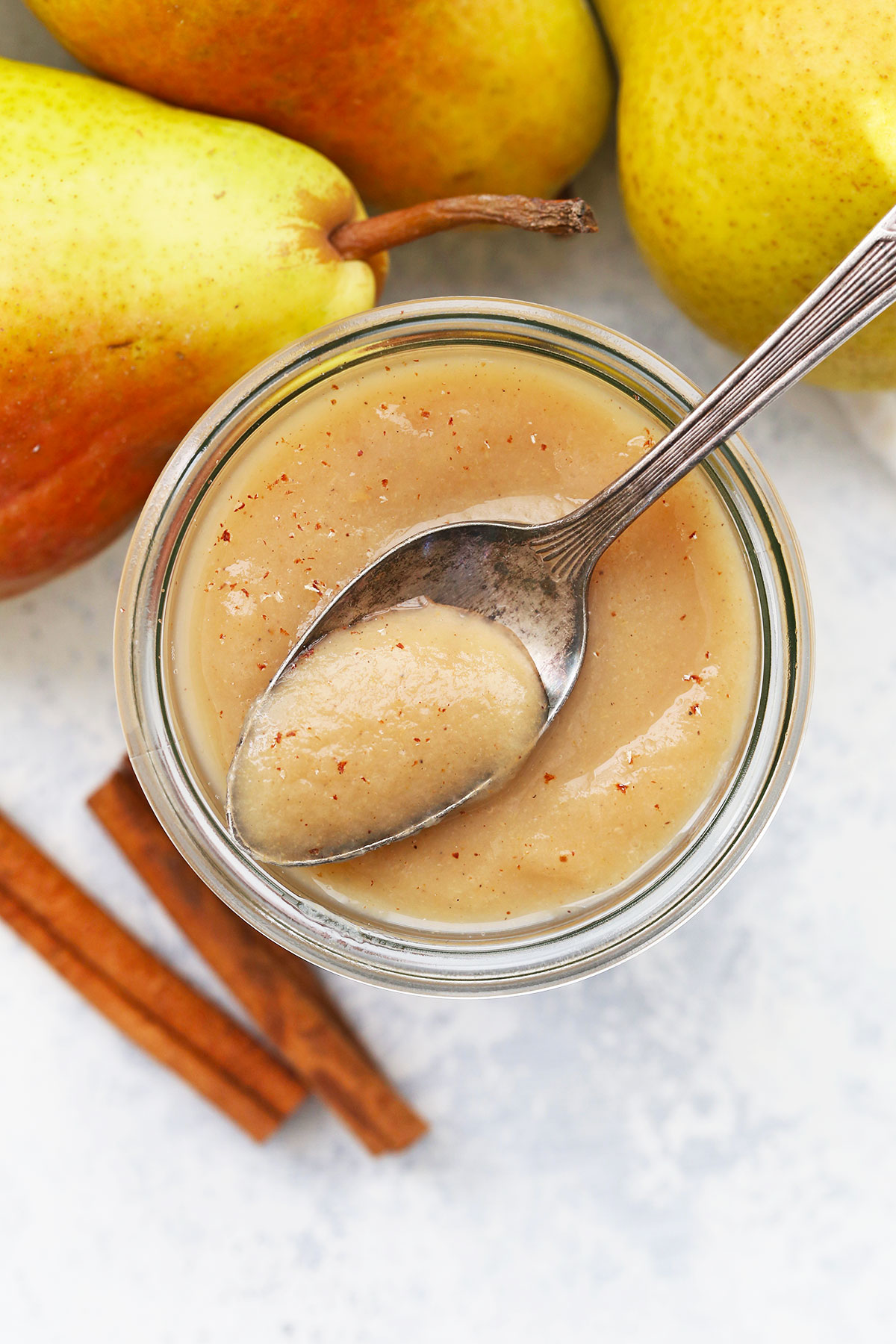 spoon dipped in a jar of pear sauce