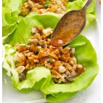 drizzling sauce over paleo chicken lettuce wraps