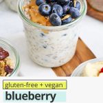 Front view of a jar of blueberry muffin overnight oats topped with fresh blueberries with text overlay that reads "gluten-free + vegan blueberry muffin overnight oats: a great meal prep breakfast"