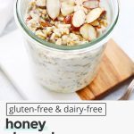 front view of a jar of honey almond overnight oats topped with sliced almonds and drizzled honey