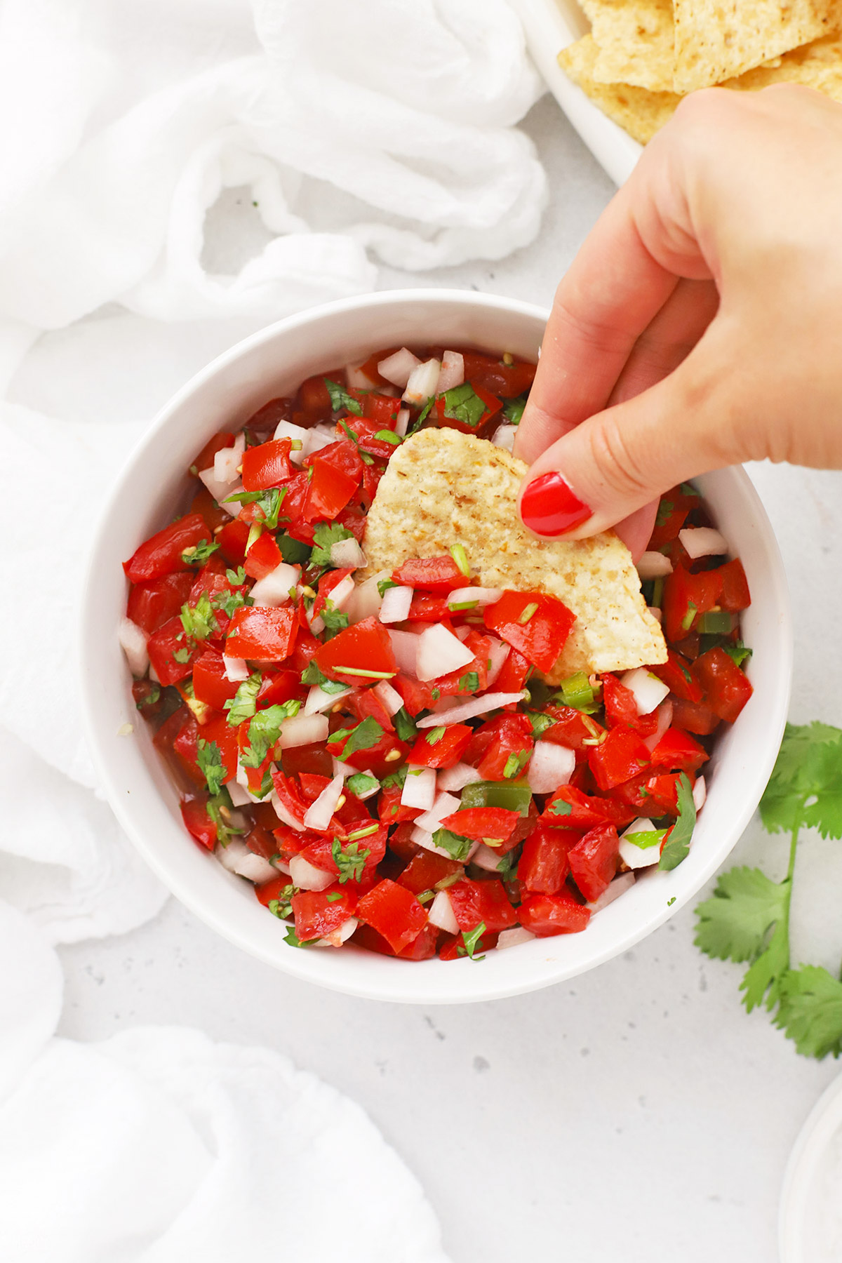 Overhead view of a bowl of authentic pico de gallo with chips